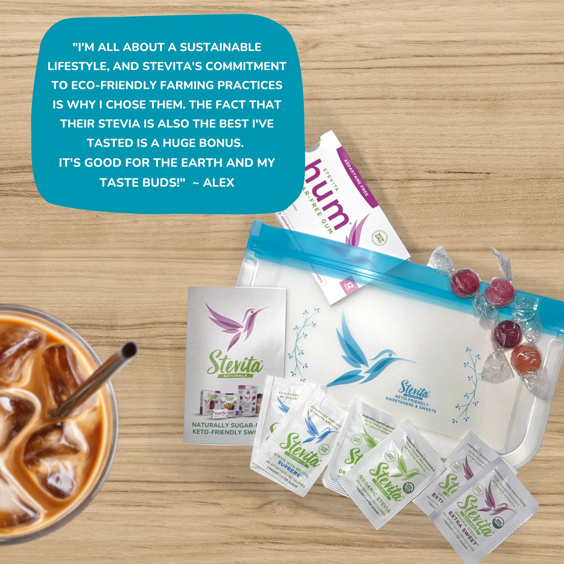 Arrangement of Stevita products with a testimonial and a glass of iced coffee on a wooden surface.